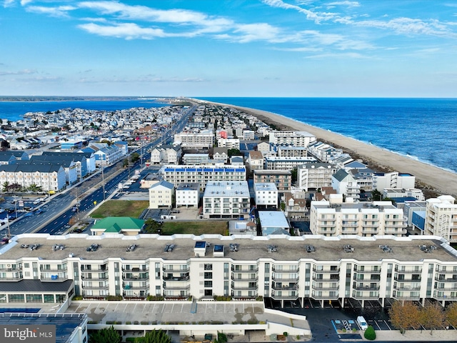 drone / aerial view with a water view and a beach view