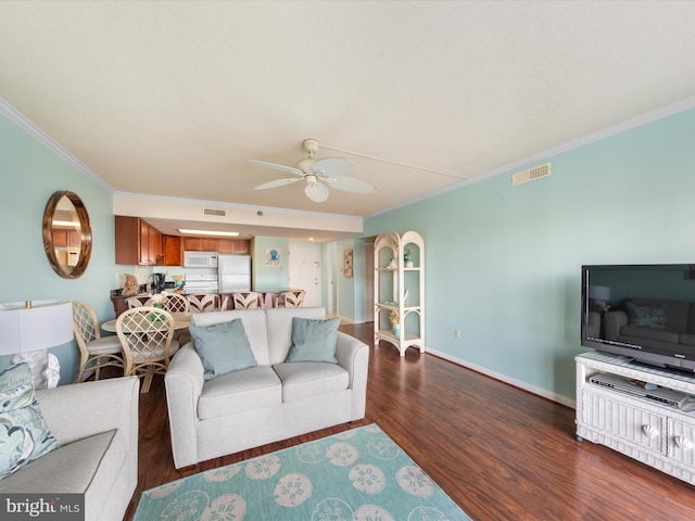 living room featuring crown molding, ceiling fan, and dark wood-type flooring