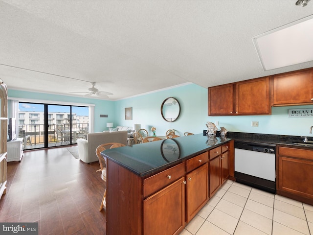 kitchen featuring kitchen peninsula, ceiling fan, white dishwasher, and a textured ceiling