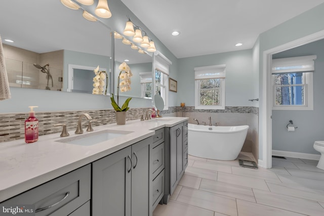 full bathroom featuring tile patterned flooring, shower with separate bathtub, vanity, and toilet