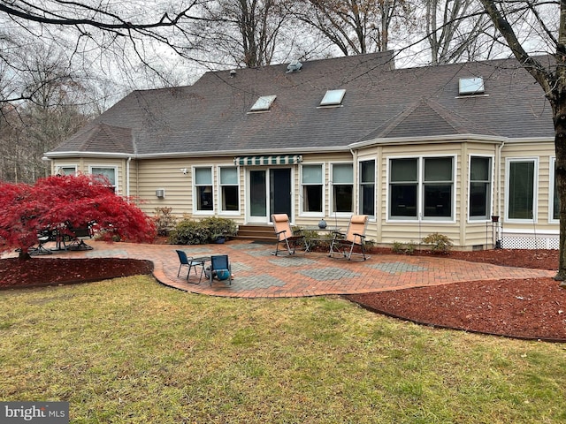 rear view of property featuring a patio area and a yard