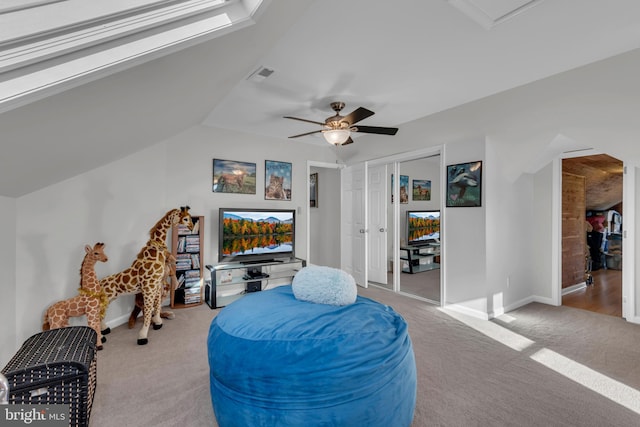 sitting room featuring light carpet, ceiling fan, and vaulted ceiling