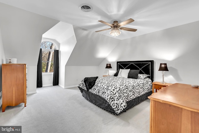 carpeted bedroom with vaulted ceiling and ceiling fan