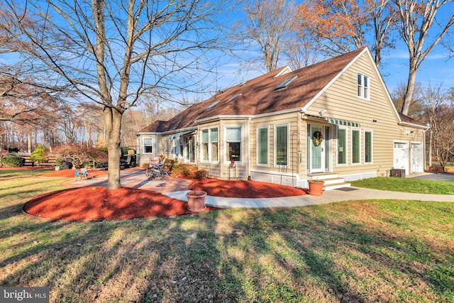 view of front of home with a front yard and cooling unit