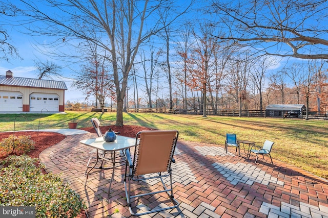 view of patio featuring a garage and an outbuilding