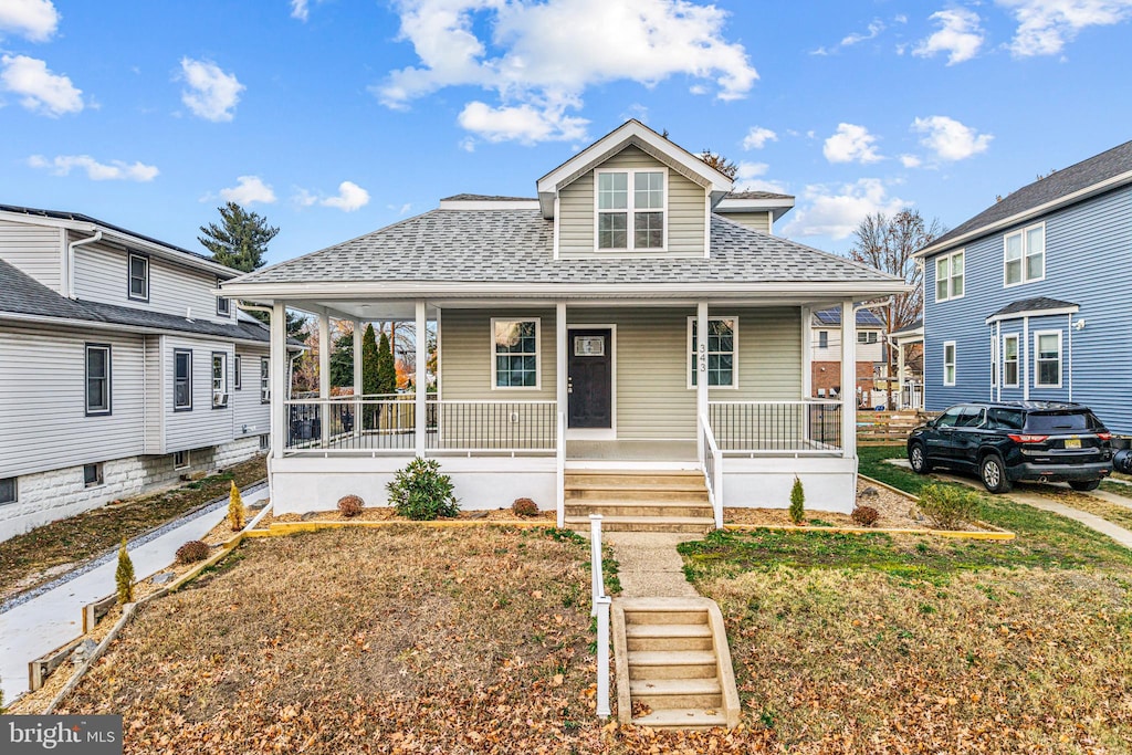 bungalow-style home featuring a porch and a front lawn