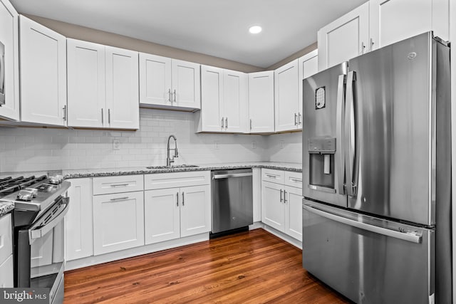 kitchen featuring dark hardwood / wood-style flooring, white cabinetry, sink, and stainless steel appliances