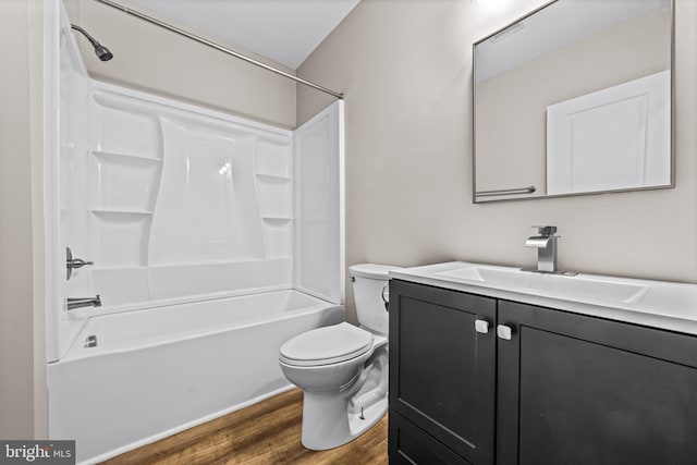 full bathroom with washtub / shower combination, vanity, hardwood / wood-style flooring, and toilet