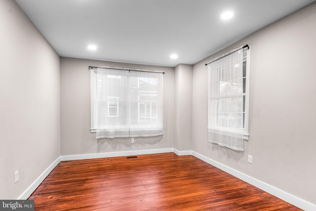 empty room featuring hardwood / wood-style floors and a wealth of natural light