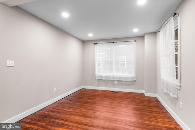 unfurnished room featuring dark hardwood / wood-style flooring