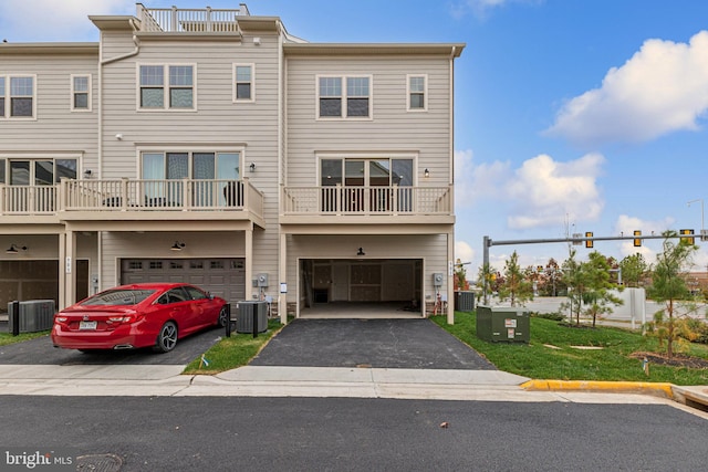 view of property with a garage and cooling unit