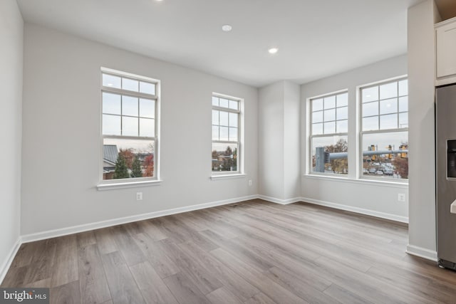 spare room featuring light hardwood / wood-style floors