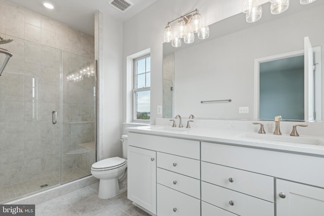 bathroom featuring tile patterned floors, vanity, toilet, and walk in shower