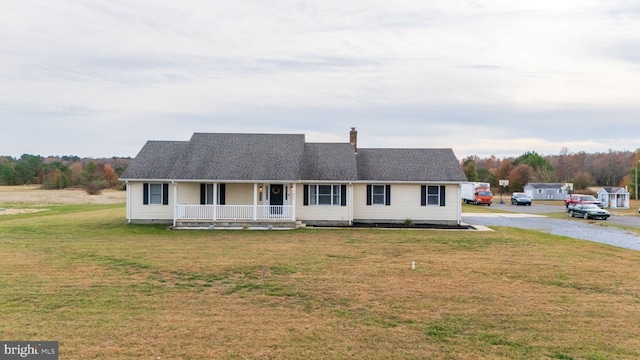 view of front of home featuring covered porch and a front yard