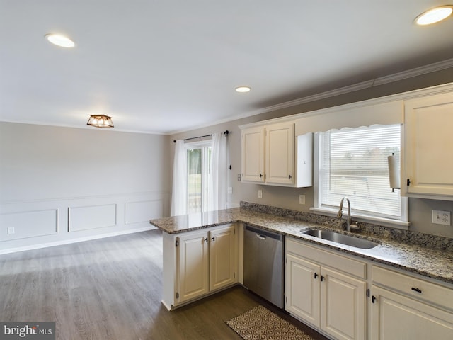 kitchen featuring kitchen peninsula, dishwasher, sink, and a healthy amount of sunlight