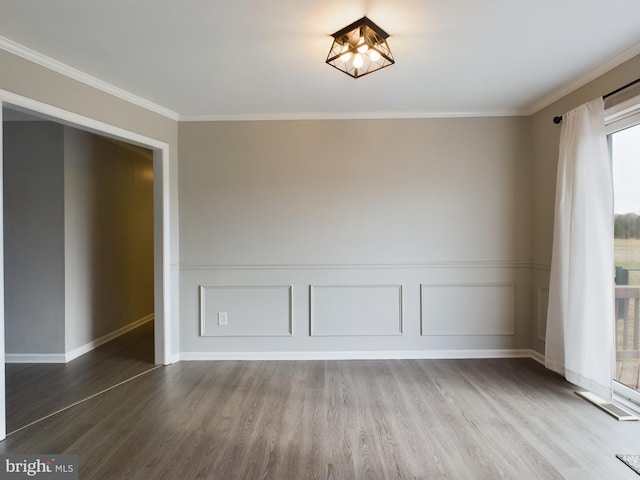 spare room with crown molding and hardwood / wood-style flooring