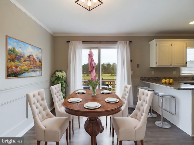 dining room featuring crown molding and dark wood-type flooring