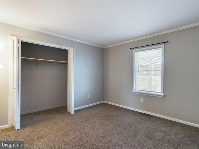 unfurnished bedroom featuring carpet, ornamental molding, and a closet