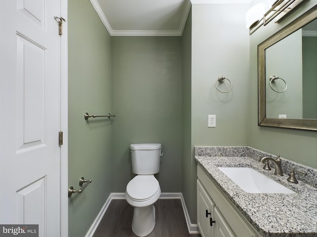 bathroom with hardwood / wood-style floors, vanity, toilet, and crown molding