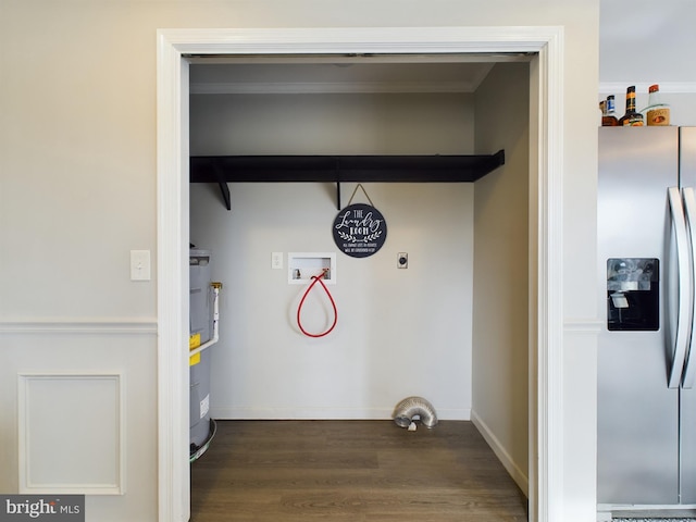 laundry area with strapped water heater, hookup for an electric dryer, dark hardwood / wood-style floors, crown molding, and hookup for a washing machine