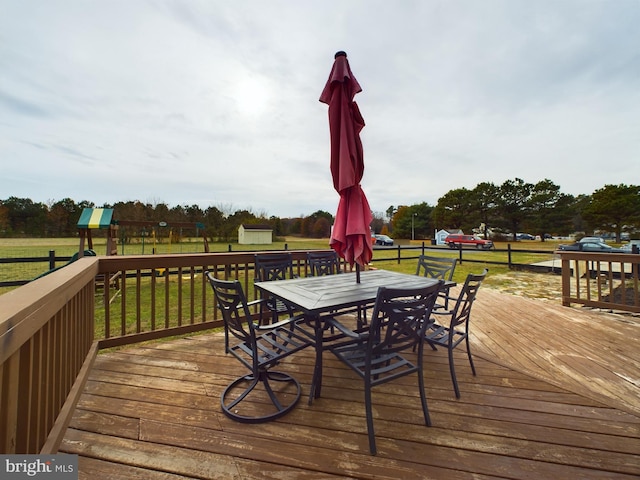 wooden terrace featuring a yard