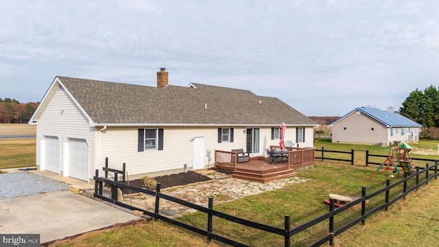 rear view of property with a lawn and a wooden deck