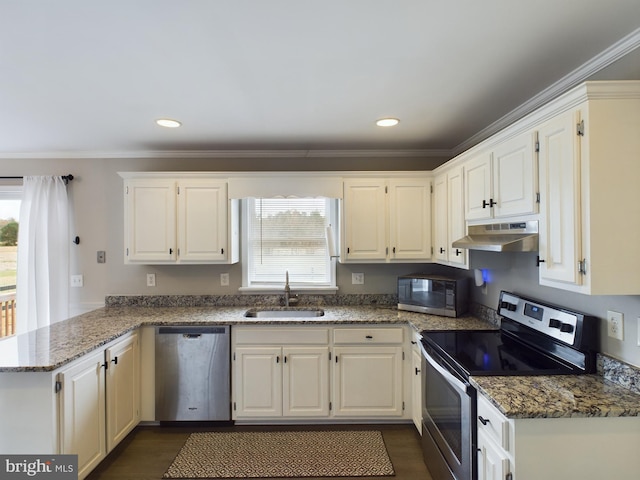 kitchen with stainless steel appliances, crown molding, sink, dark stone countertops, and white cabinets