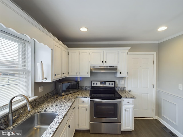 kitchen with sink, appliances with stainless steel finishes, stone countertops, dark hardwood / wood-style flooring, and white cabinetry