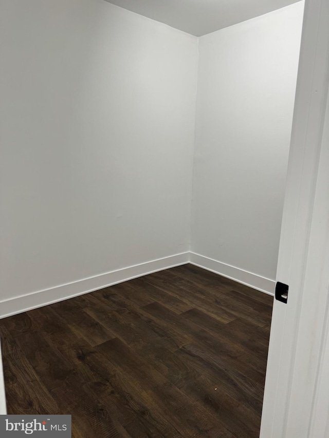 spare room featuring dark hardwood / wood-style flooring