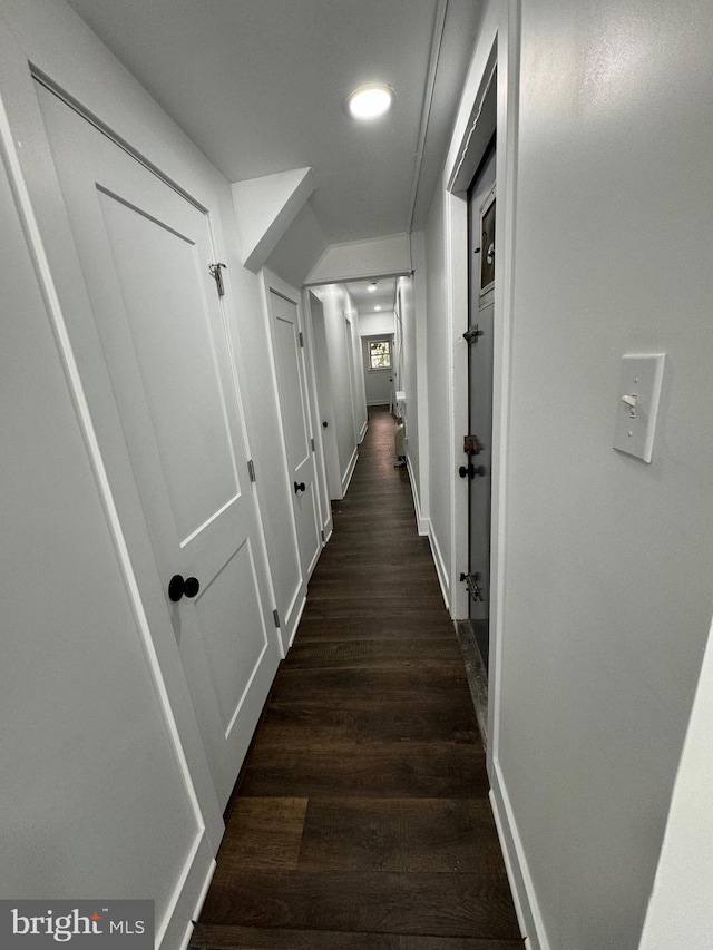 hall with dark hardwood / wood-style floors