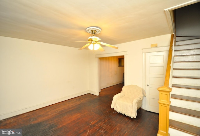 unfurnished room with ceiling fan and dark hardwood / wood-style flooring