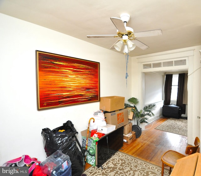 living area featuring hardwood / wood-style flooring and ceiling fan