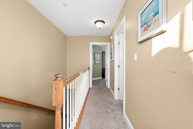 hall featuring light colored carpet