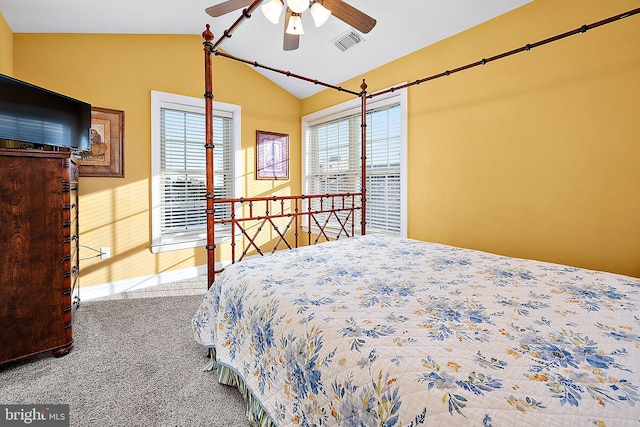 bedroom featuring carpet, ceiling fan, vaulted ceiling, and multiple windows