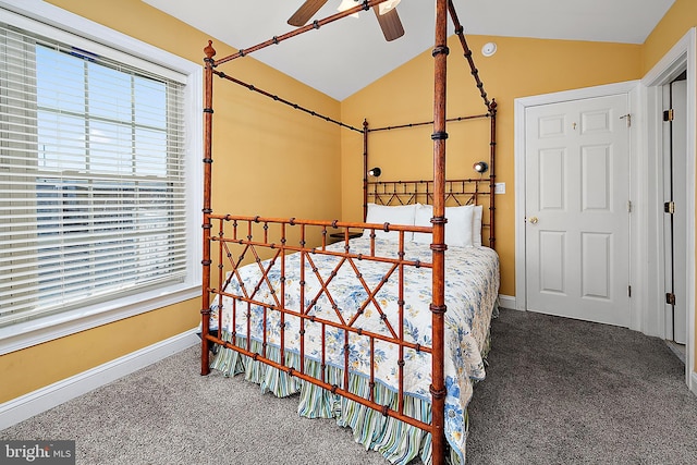 carpeted bedroom with vaulted ceiling, multiple windows, and ceiling fan