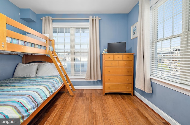 bedroom with hardwood / wood-style floors