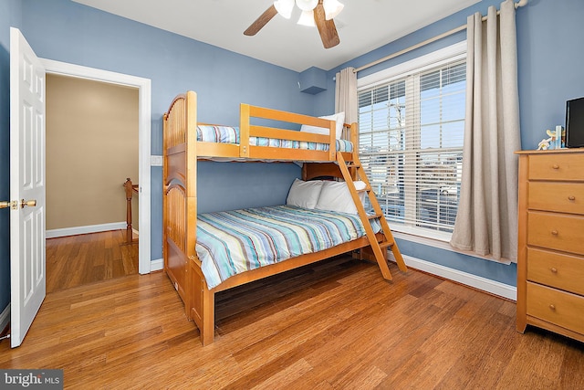 bedroom with ceiling fan and wood-type flooring