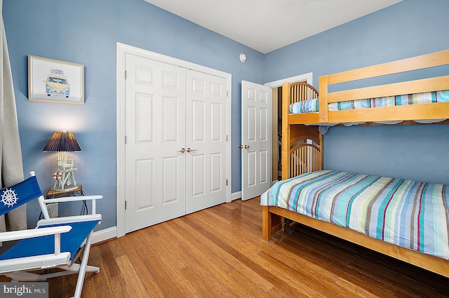 bedroom with a closet and hardwood / wood-style floors