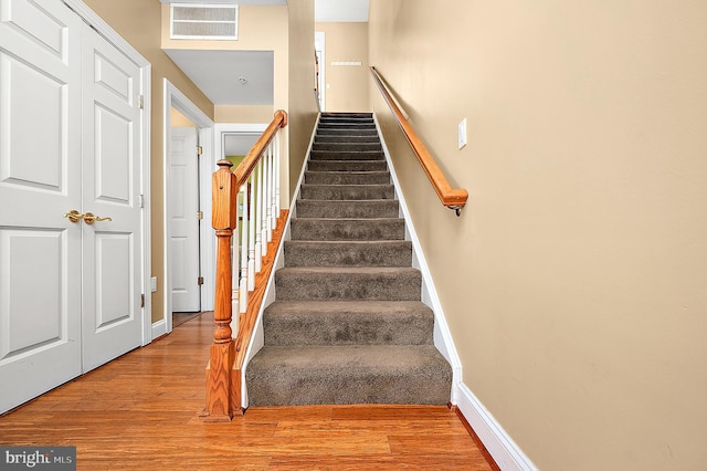 stairs featuring wood-type flooring