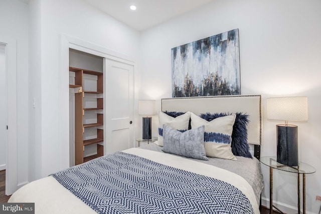 bedroom with hardwood / wood-style flooring and a closet