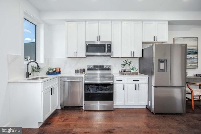 kitchen featuring dark wood-type flooring, white cabinetry, sink, and stainless steel appliances