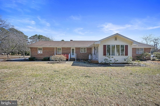 ranch-style home featuring brick siding and a front lawn