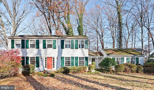 colonial home with a front lawn