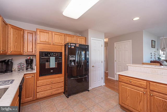 kitchen featuring light tile patterned floors and black appliances