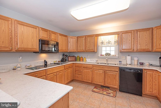 kitchen featuring sink, light tile patterned floors, and black appliances