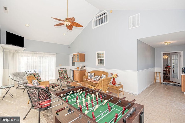 game room with ceiling fan, high vaulted ceiling, and light tile patterned floors