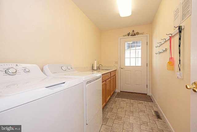 washroom featuring washer and clothes dryer, cabinets, and sink