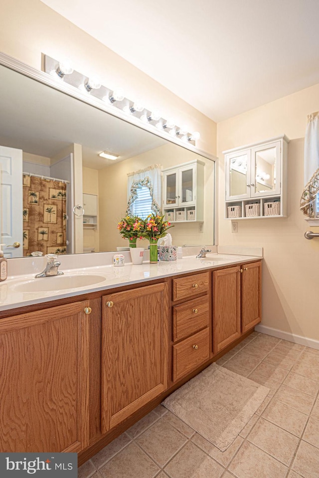 bathroom with tile patterned floors and vanity