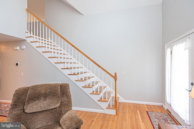 entryway featuring a high ceiling and light hardwood / wood-style floors