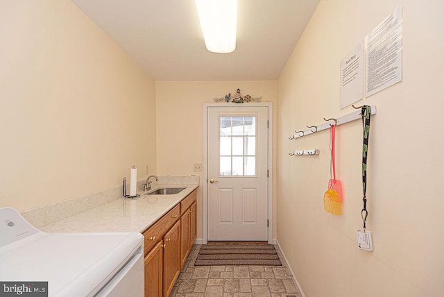 laundry room featuring sink, cabinets, and washer / dryer